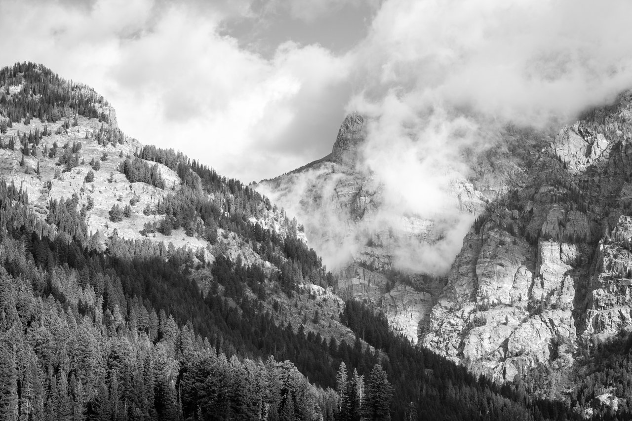 The rocky walls of Death Canyon, surrounded by clouds.