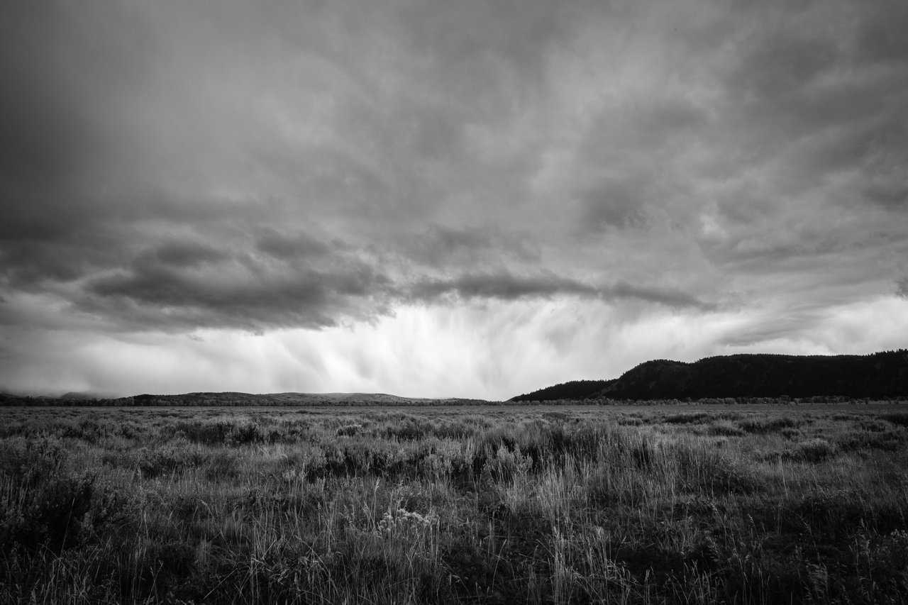 A storm dumping snow on Antelope Flats in Grand Teton National Park. Blacktail Butte can be seen to the right.
