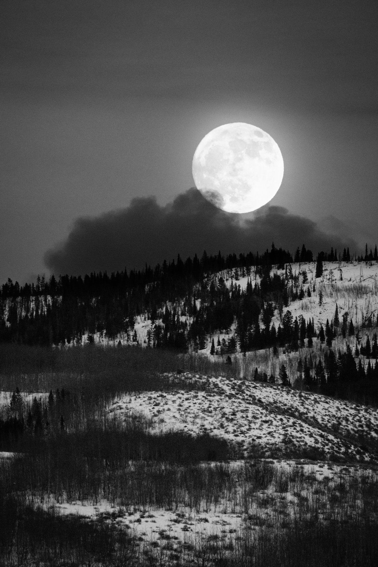 The full moon rising over the hills east of Antelope Flats during winter solstice.