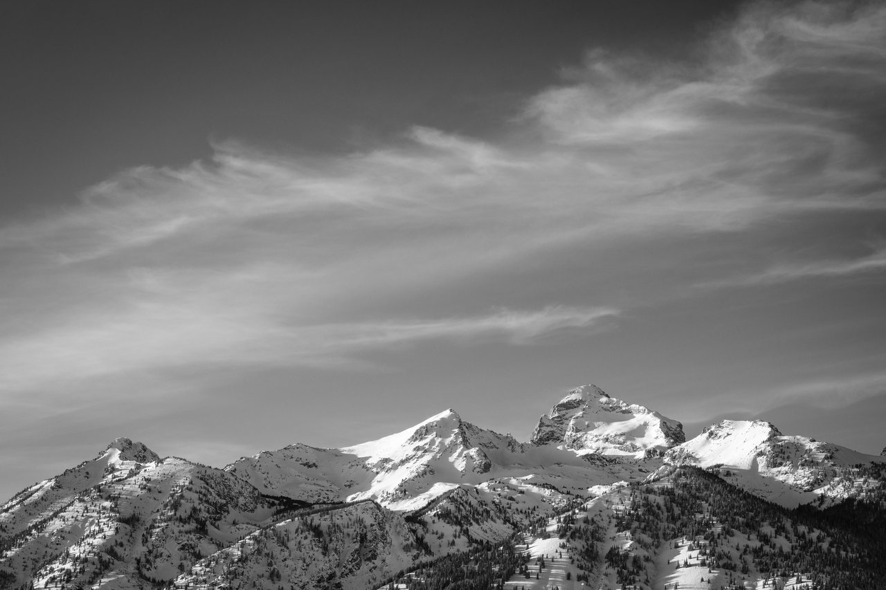 Static Peak & Buck Mountain seen in winter under whispy clouds.